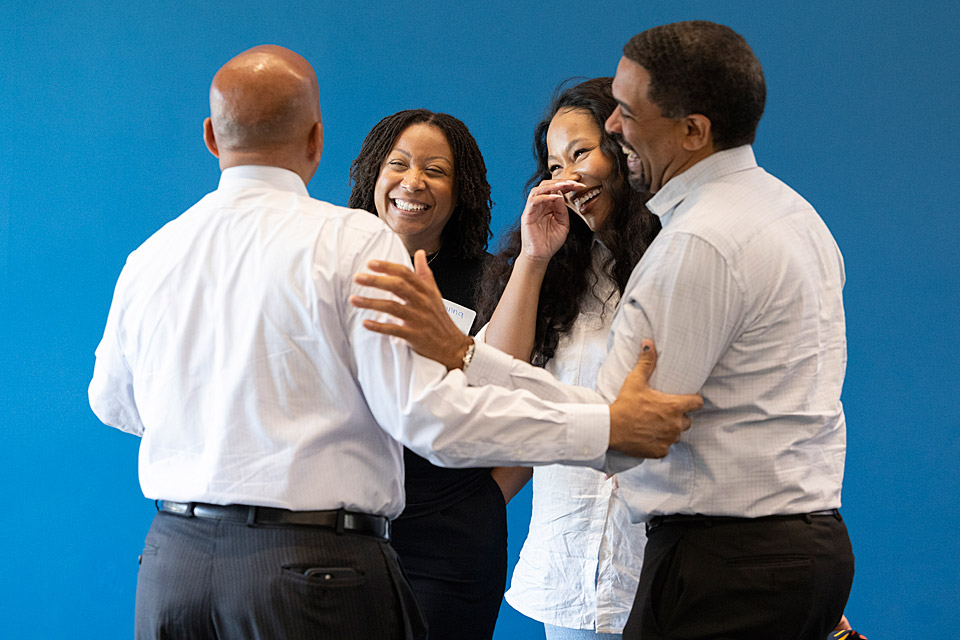 President Rochon convening with members in a huddle for a lively conversation