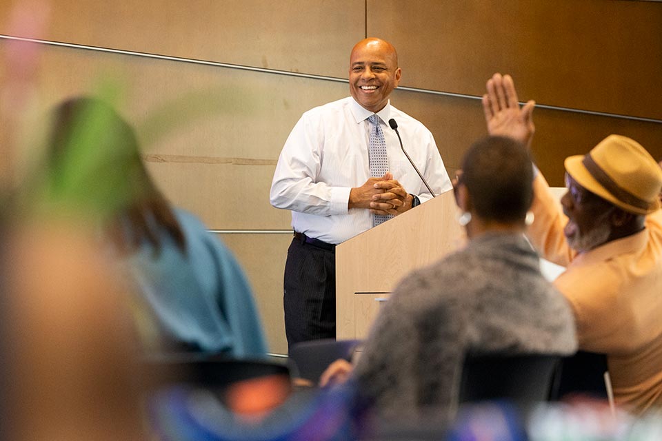 President Rochon smiles at the podium.