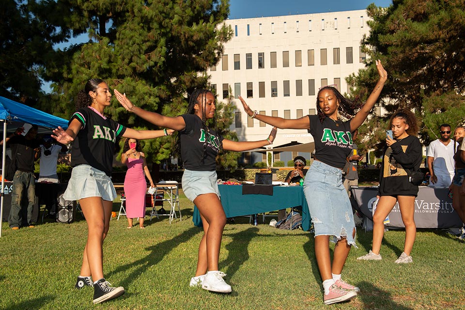 Three female students dancing