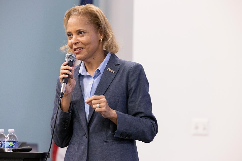 HRDI Vice President Phoenicia McCullough speaks into a microphone.