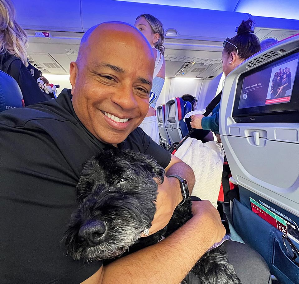 President Rochon holding Jaz while in airplane.