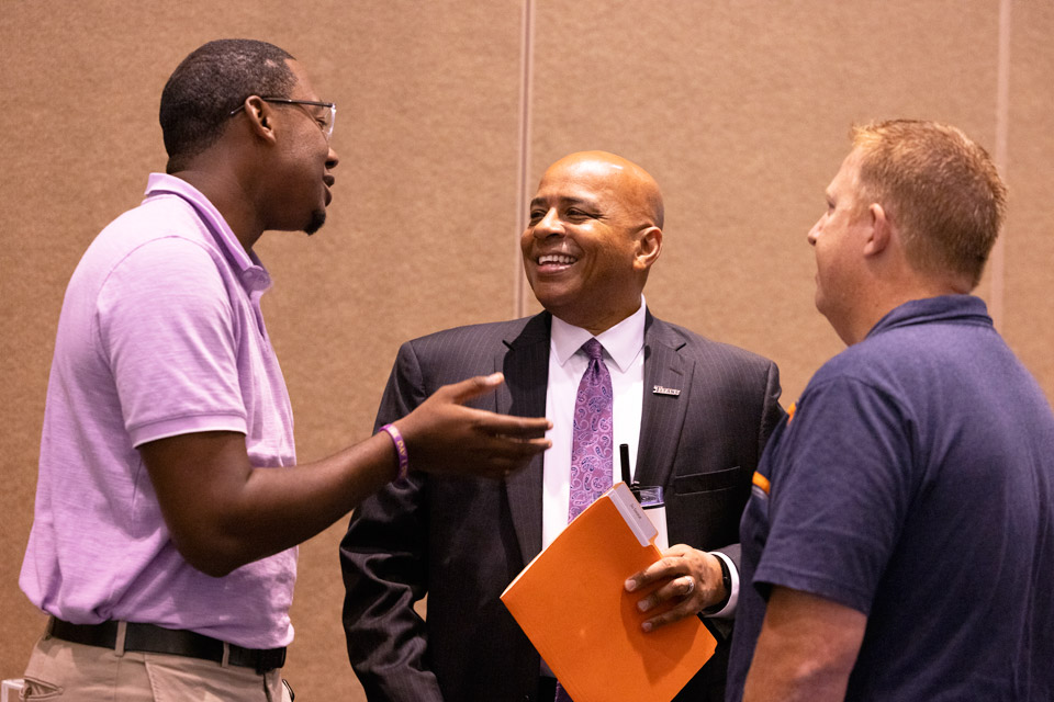 President Rochon conversing with members of Student Affairs