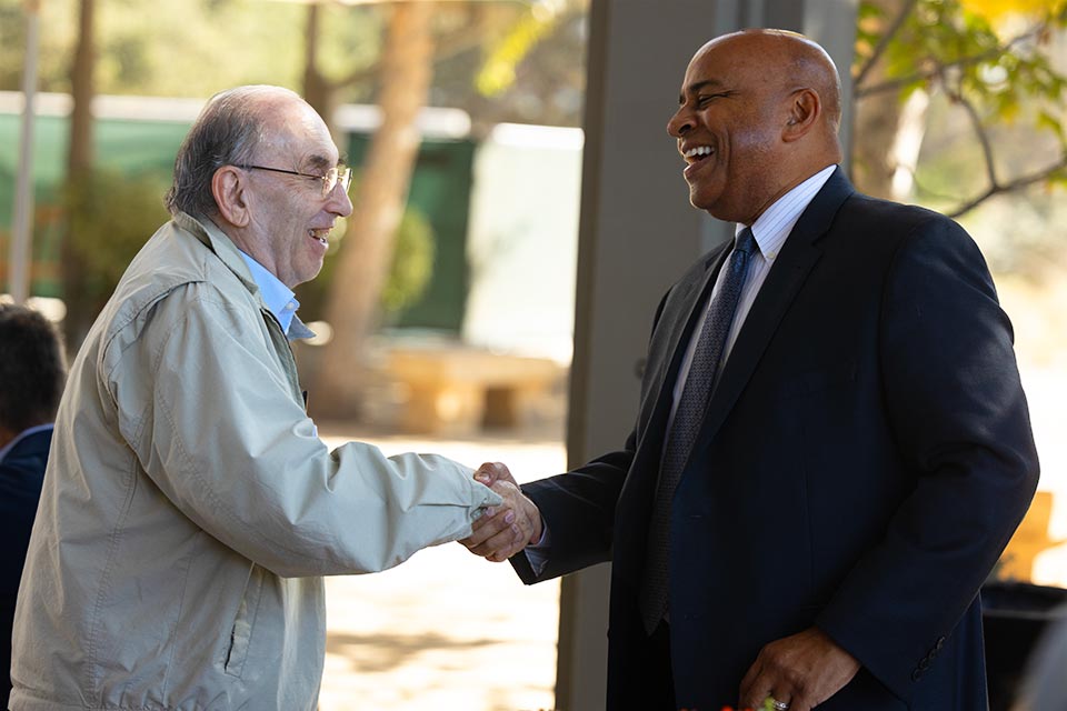 President Rochon shaking hands with an emeritus