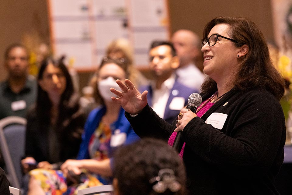 An attendee speaking with microphone in hand