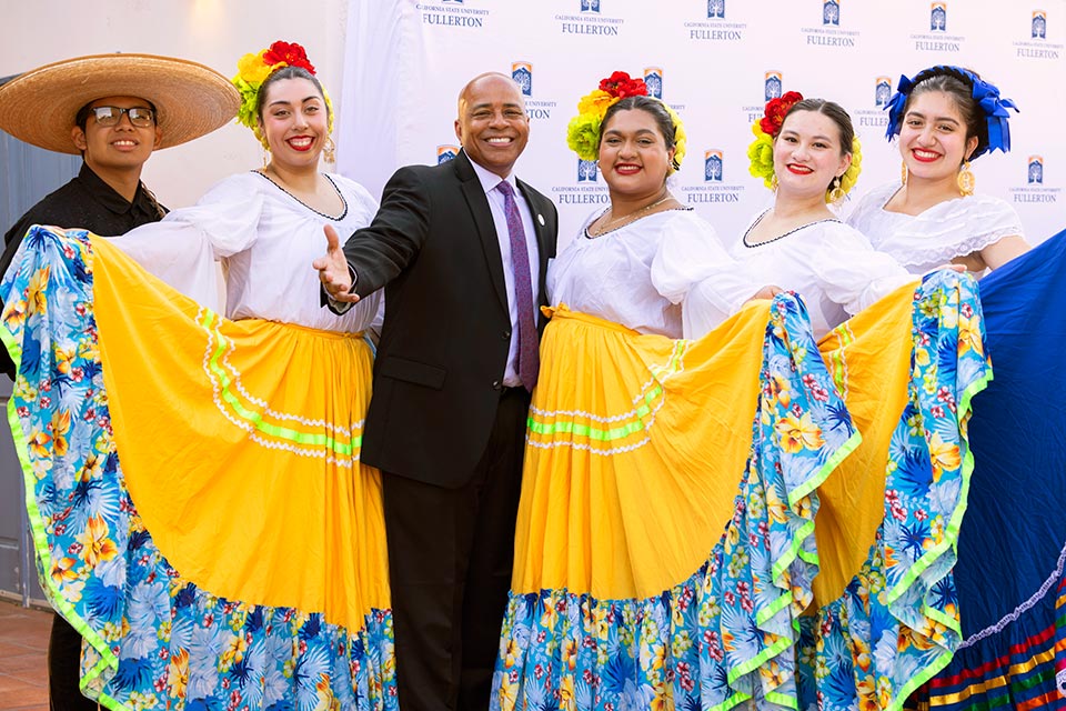 President Rochon posing with Folklorico dancers.