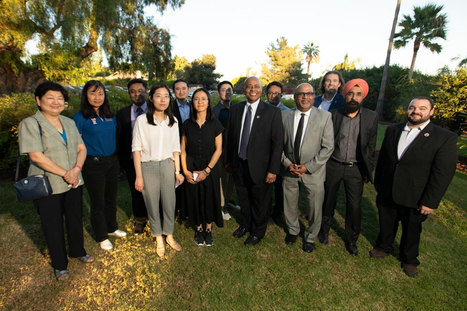 President Rochon posing with new faculty members