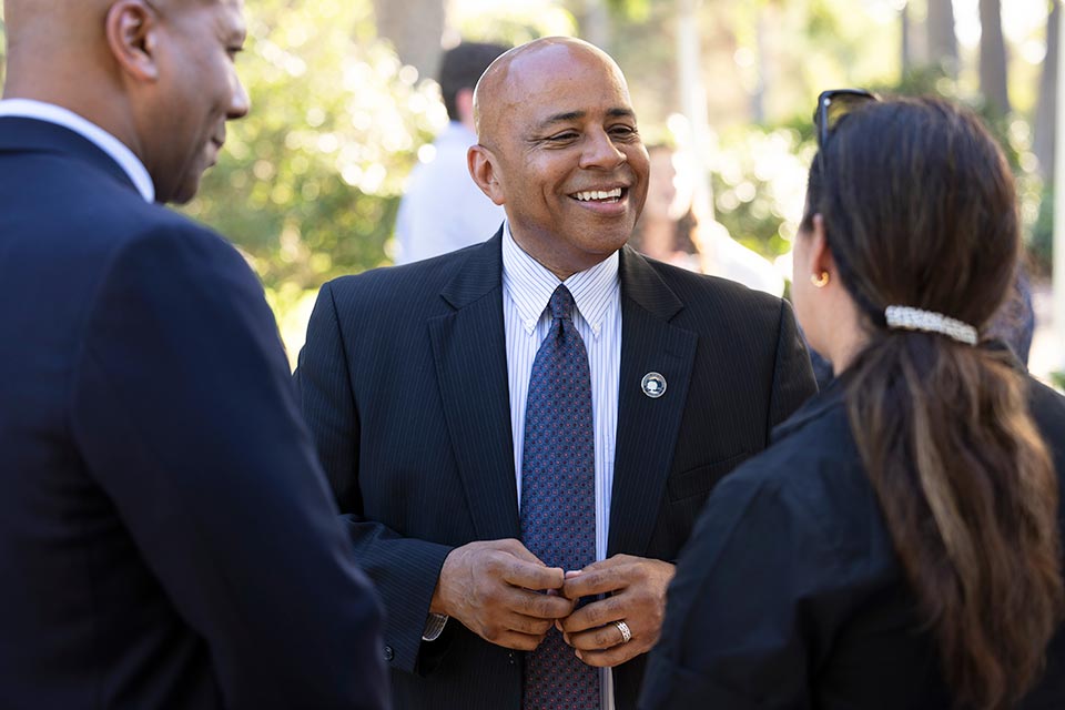 President Rochon conversing with a group of faculty members.