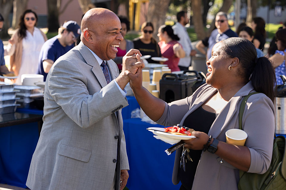 President Rochon high fives a staff member