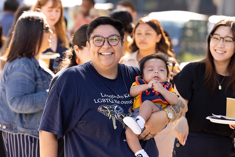 An employee holding her infant child