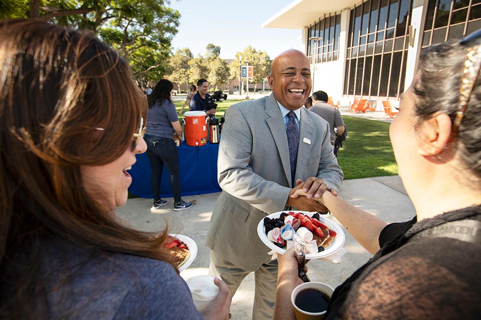 President Rochon greeting and shaking hands with an employee.