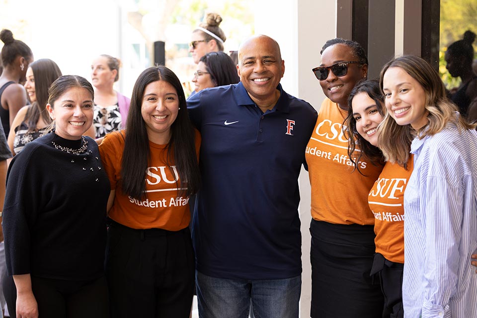 President Rochon posing with CSUF members.