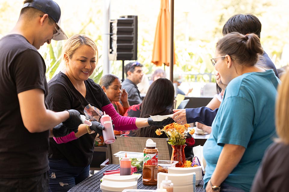 Volunteers serving popsicles to attendees.