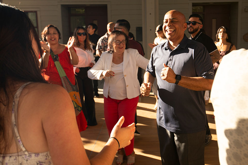 President Rochon dancing with a group of attendees.