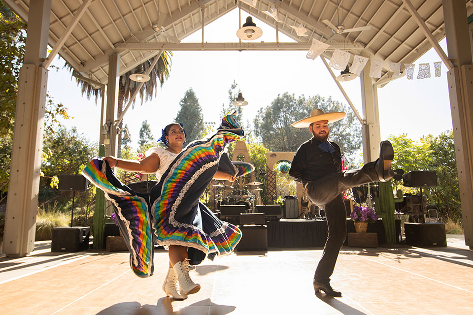 Female and male folklorico dancers performing