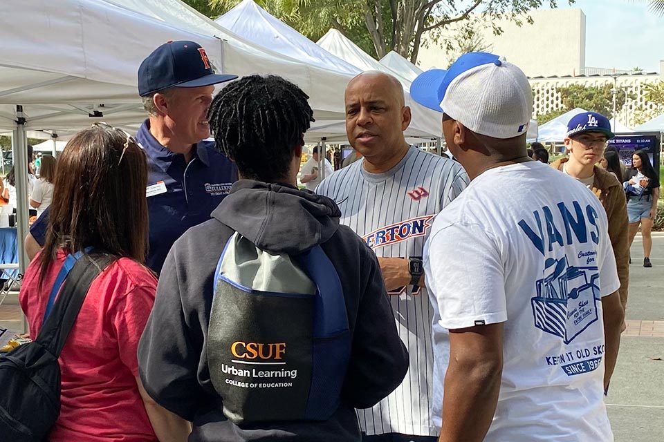 President Rochon conversing with student and parents