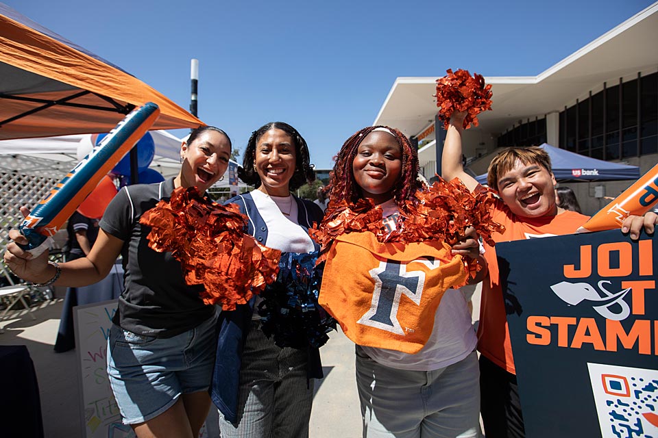 Group of students with pompoms cheering