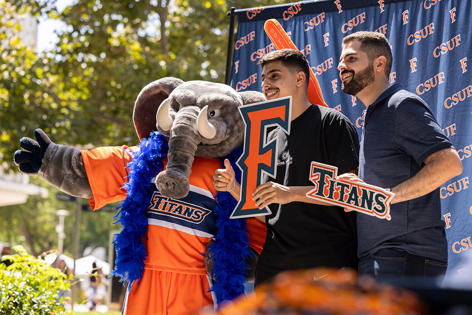 Tuffy mascot with male students