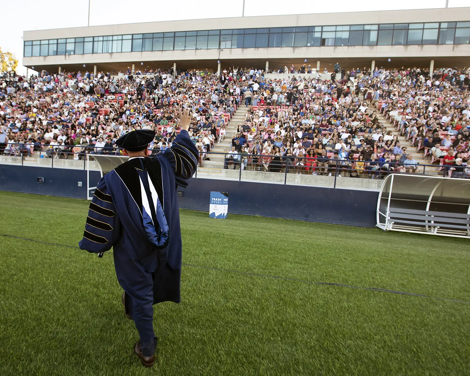 President Rochon waving to commencement crowd