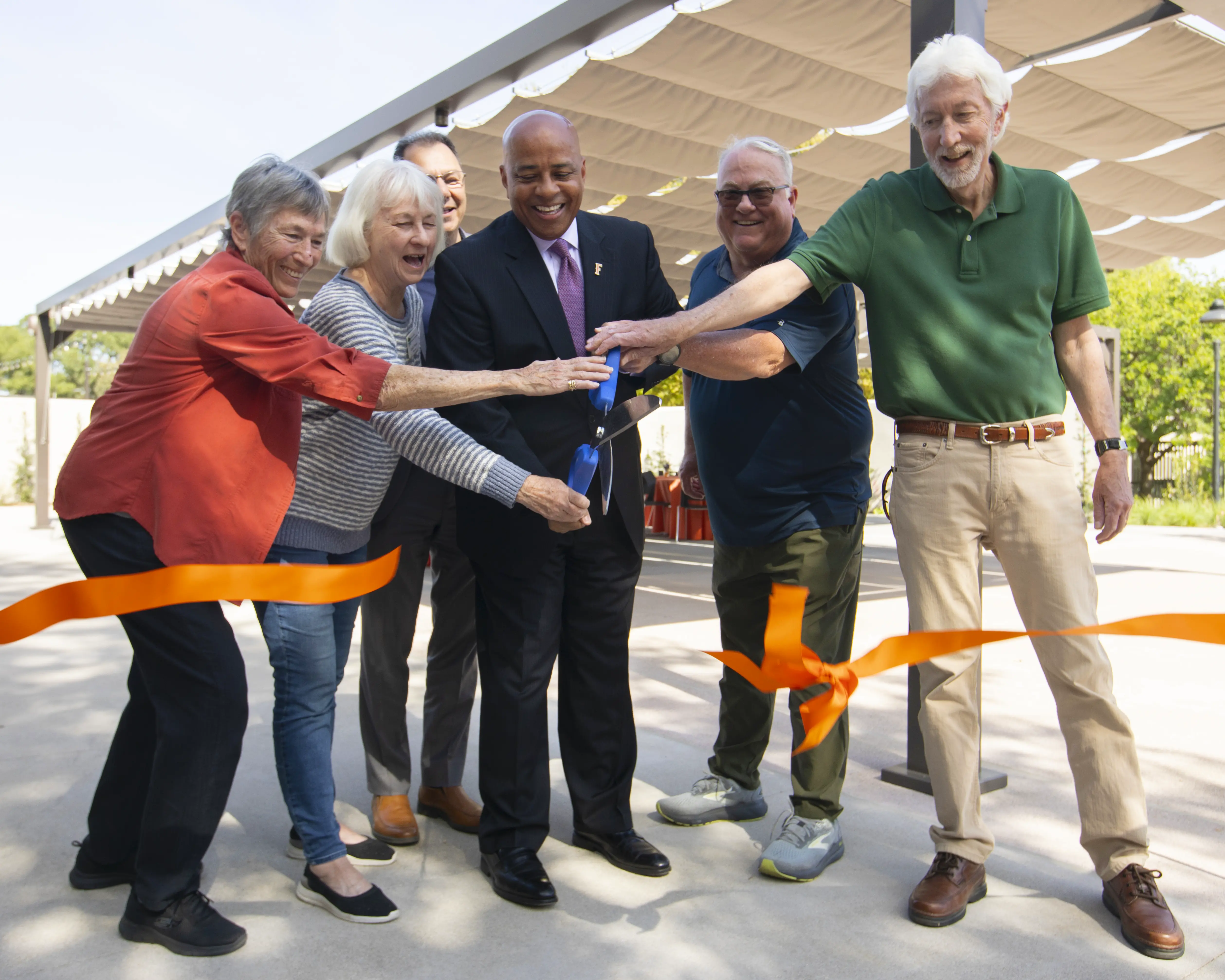 President Rochon cutting ribbon